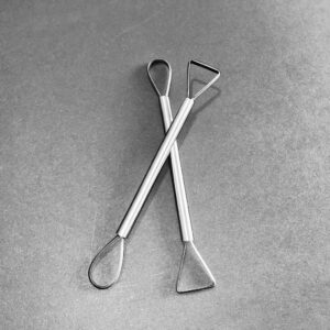 A DOUBLE ENDED TRIMMING TOOL, ONE WITH A TRIANGLE & A ROUND END.